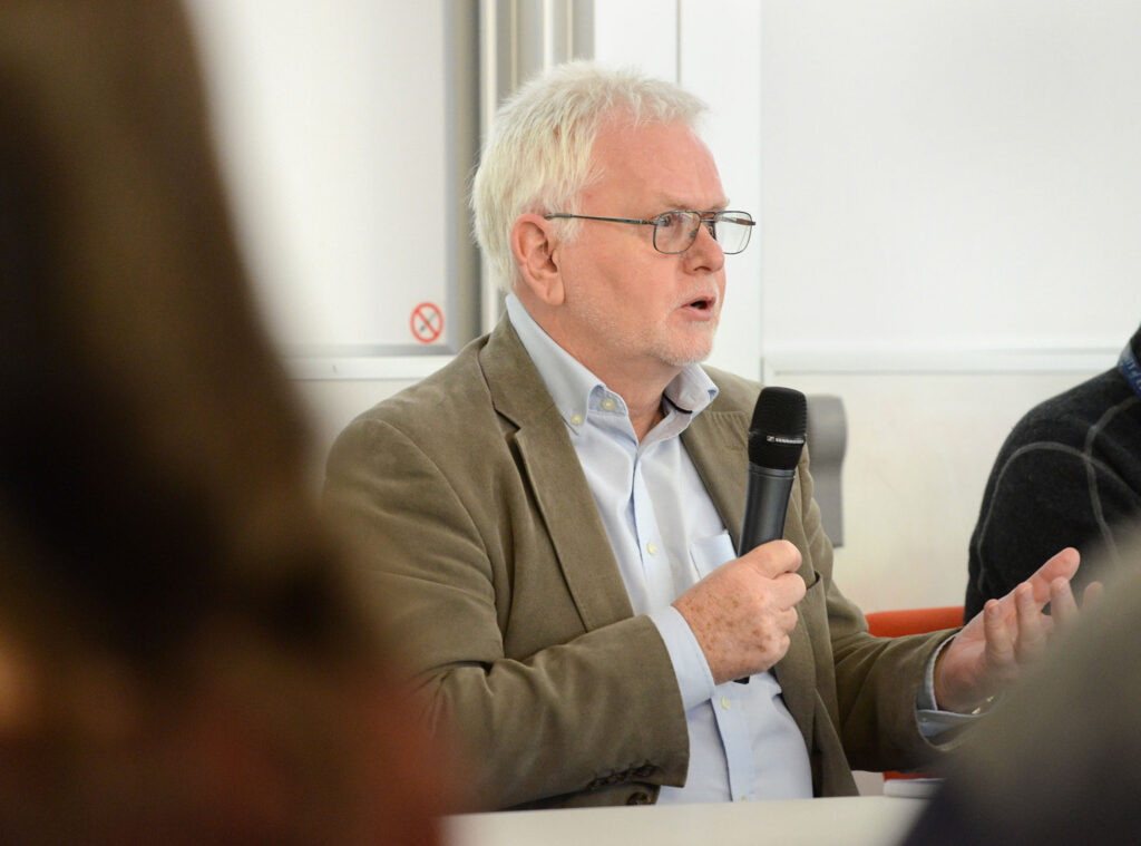 Prof Andy Peters speaks into a microphone at a SEBI-Livestock event